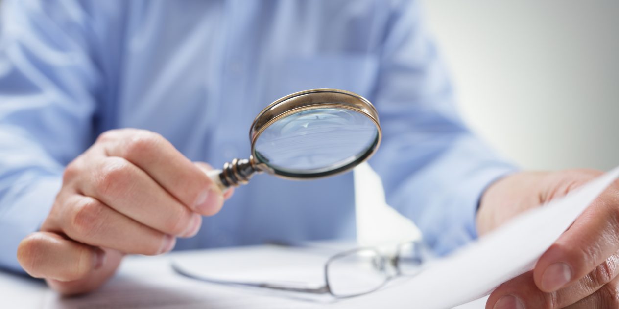 A magnifying glass reading fine print in contracts