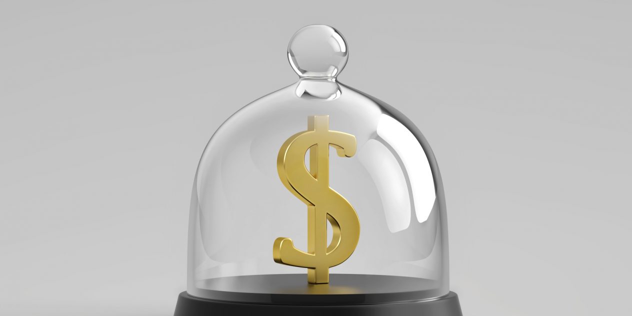 A physical gold dollar sign in a glass enclosure representing a trust