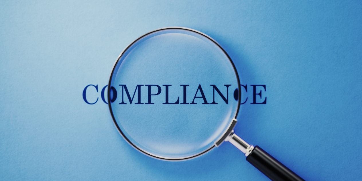 Magnifying glass emphasizing compliance with CBCA Regulations